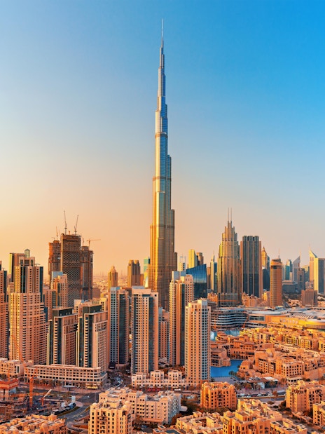 Dubai skyline with Burj Khalifa towering over modern skyscrapers.
