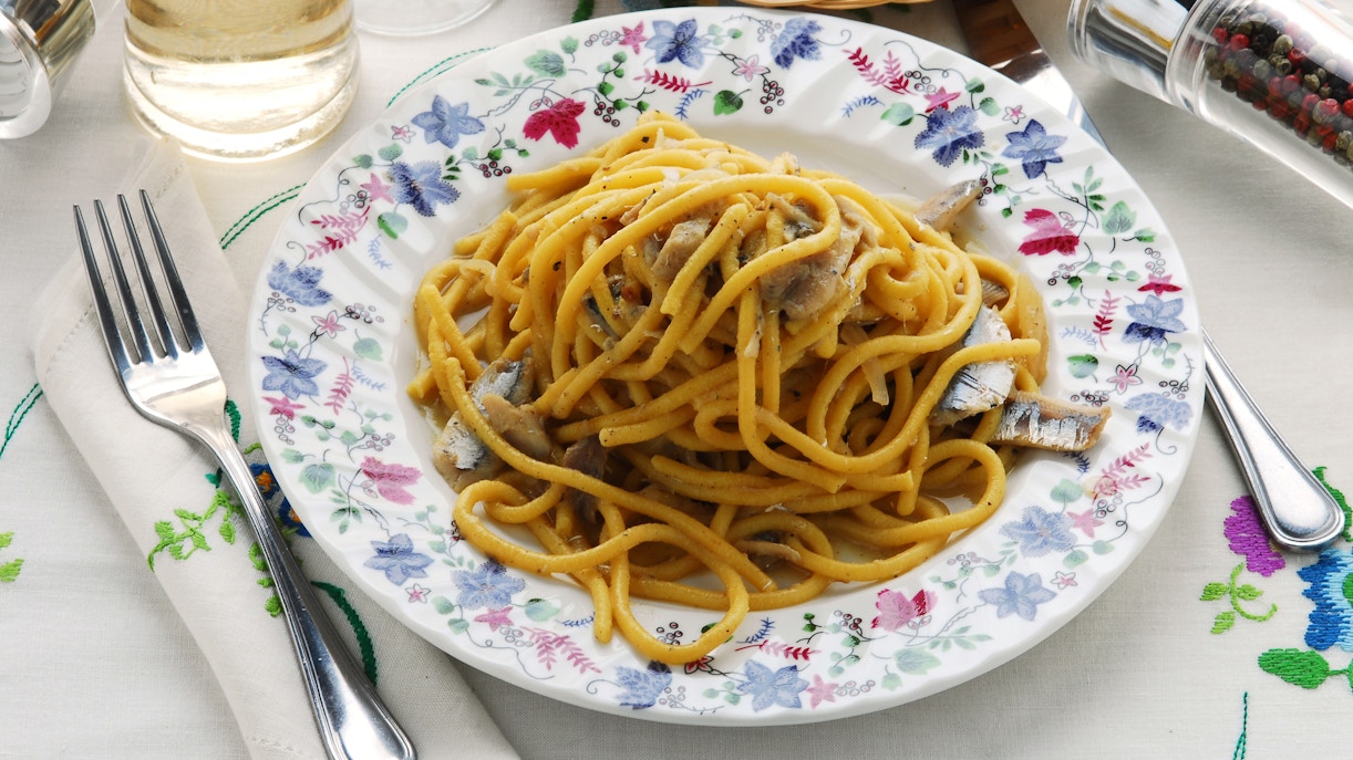 Bigoli in salsa dish served in a Venetian restaurant, highlighting Venice's culinary experience in September.