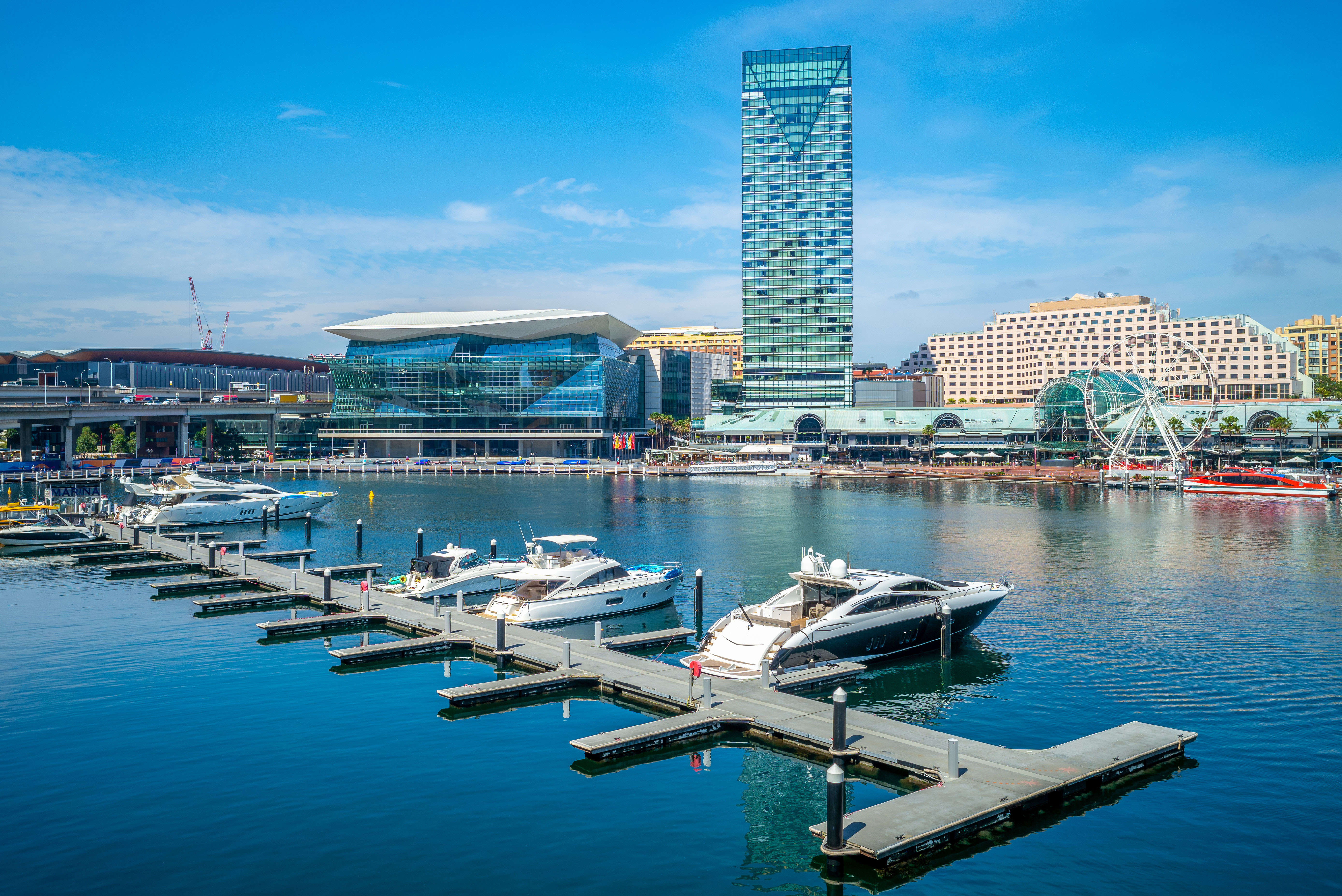 Boats docked at Darling Harbour with Sydney skyline in the background.