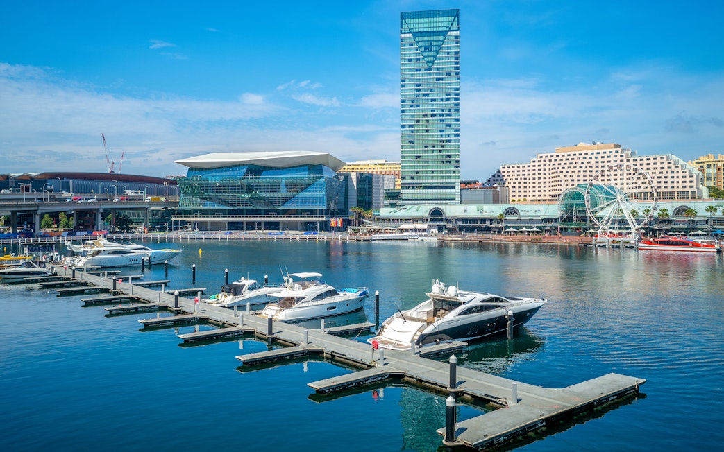 Boats docked at Darling Harbour with Sydney skyline in the background.
