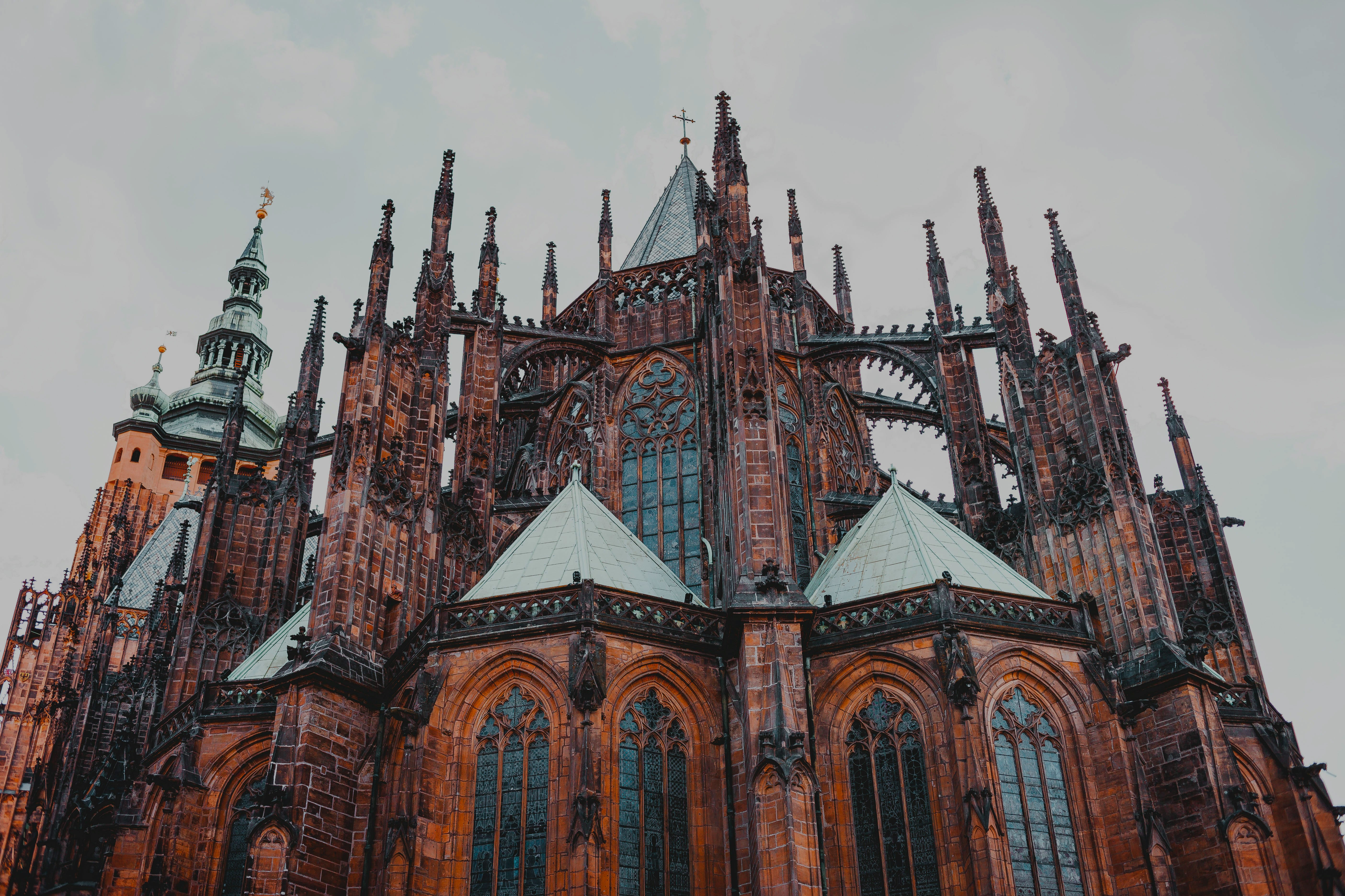 Prague Castle with tourists walking in the courtyard, showcasing historic architecture.