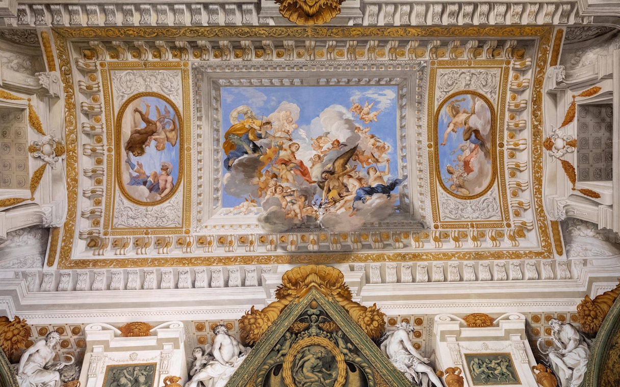 Pitti Palace exterior with visitors on guided tour in Florence, Italy.