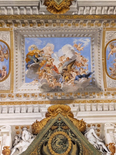 Pitti Palace exterior with visitors on guided tour in Florence, Italy.