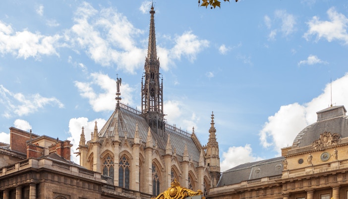 Saint Chapelle and Conciergerie in Paris under a clear June sky.
