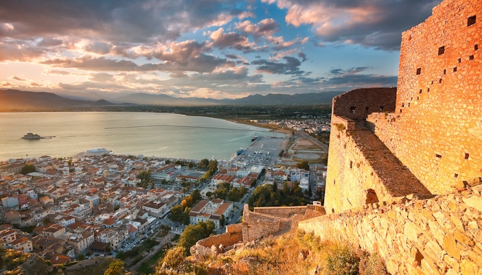 Nafplio harbor with sailboats and historic buildings in the background.