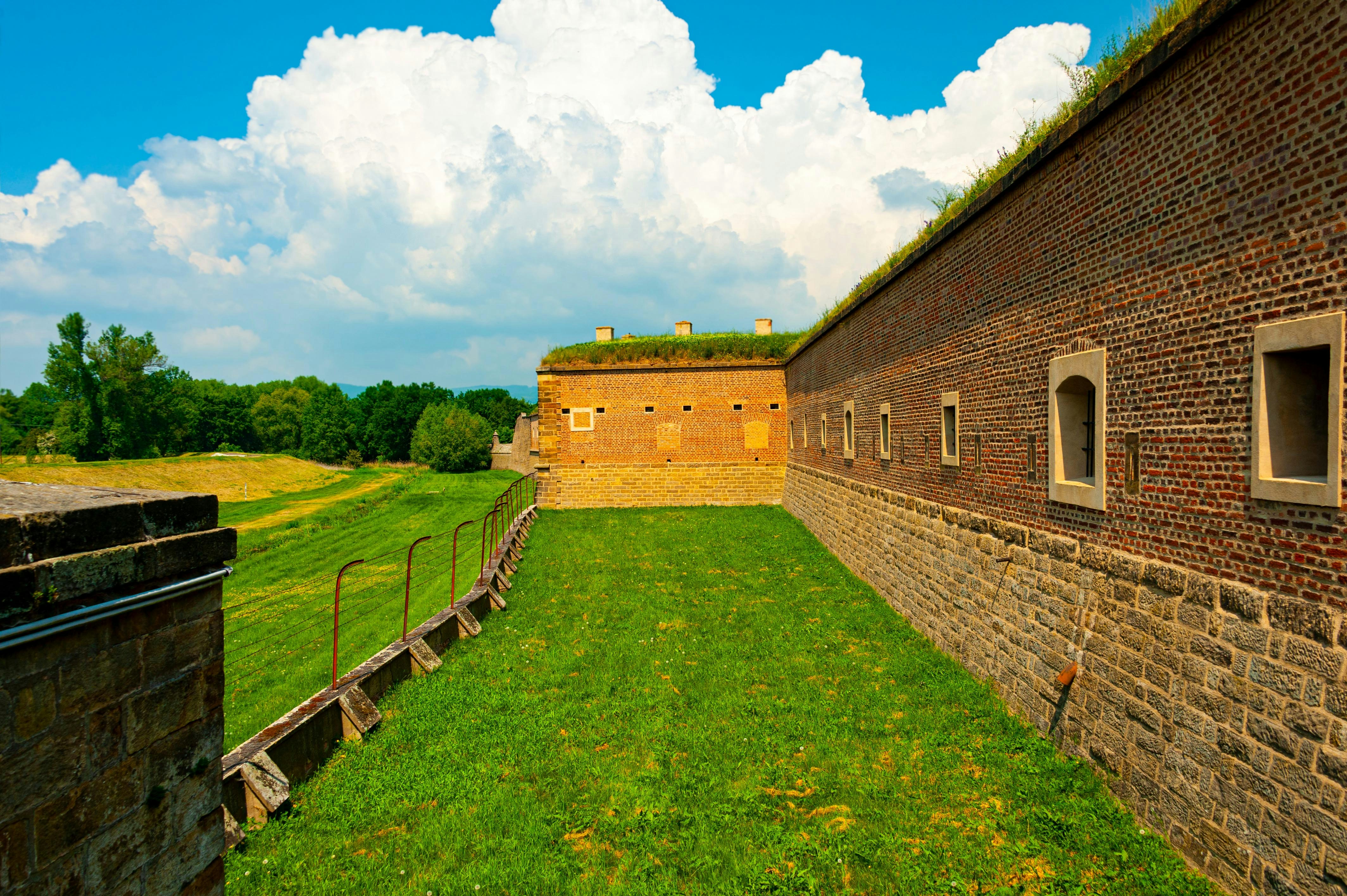 Historic fortress walls and green landscape near Prague in October.