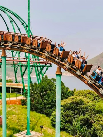 Ocean Park Hong Kong roller coaster with city skyline in background.