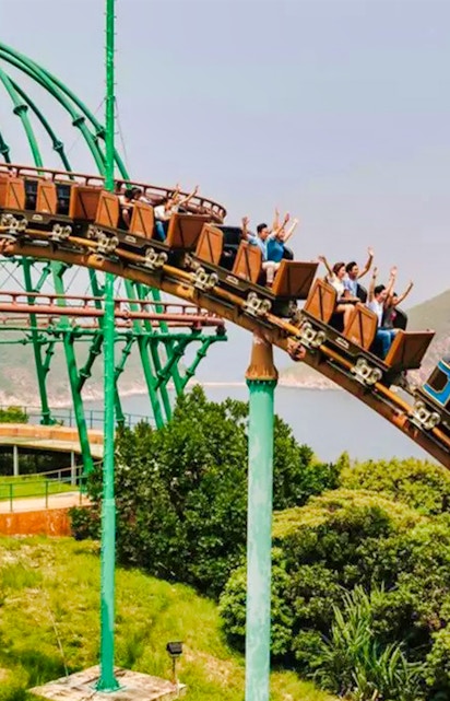 Ocean Park Hong Kong roller coaster with city skyline in background.