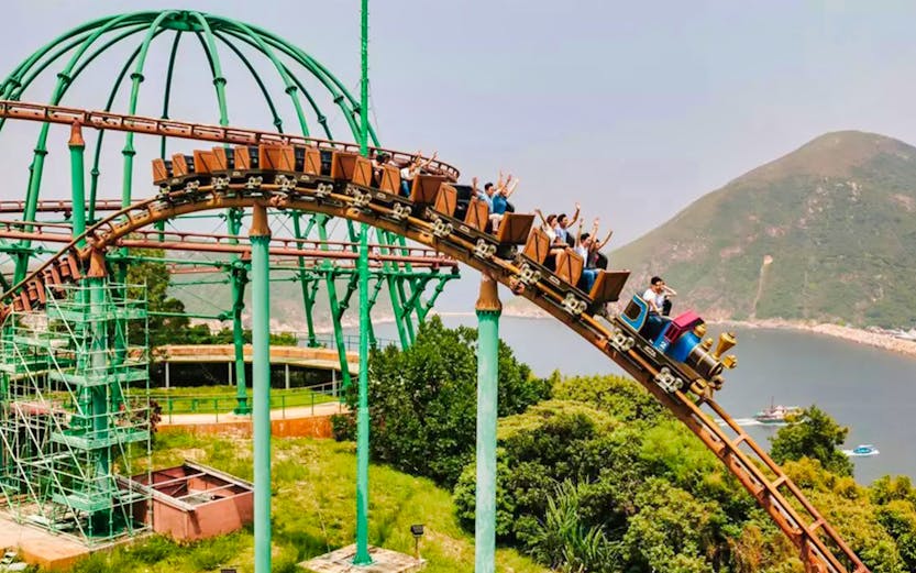 Ocean Park Hong Kong roller coaster with city skyline in background.