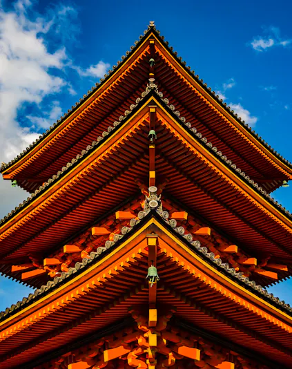 Kyoto's Kinkaku-ji Temple with golden pavilion reflecting in serene pond.