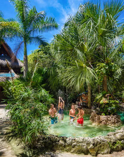 Xplor Park zip-lining adventure in Cancun, Mexico, showcasing lush jungle scenery.