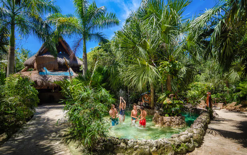 Xplor Park zip-lining adventure in Cancun, Mexico, showcasing lush jungle scenery.