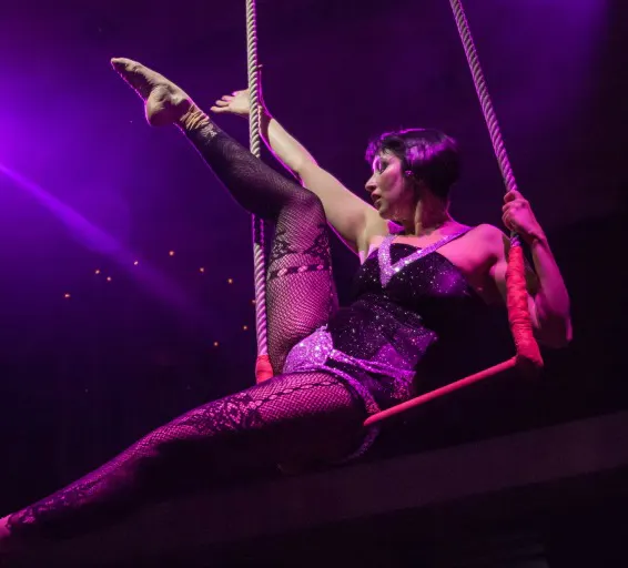 Cabaret performance at a Parisian venue with dancers in vibrant costumes.