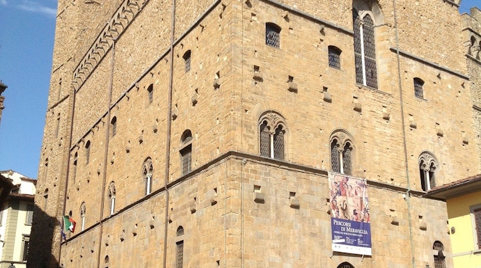 Museo del Bargello exterior in Florence, Italy, with visitors and bicycles nearby.