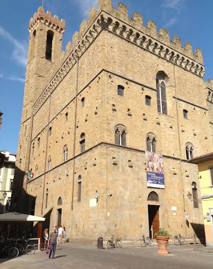 Museo del Bargello exterior in Florence, Italy, with visitors and bicycles nearby.
