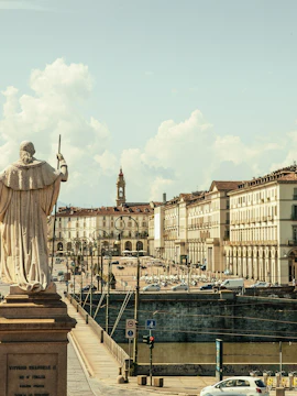 Statue overlooking Piazza Vittorio Veneto with Mole Antonelliana in Turin, Italy.