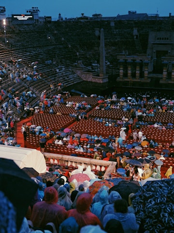 Crowd with umbrellas at Arena di Verona opera event in Verona, Italy.