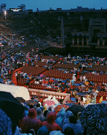 Crowd with umbrellas at Arena di Verona opera event in Verona, Italy.