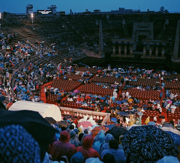 Crowd with umbrellas at Arena di Verona opera event in Verona, Italy.