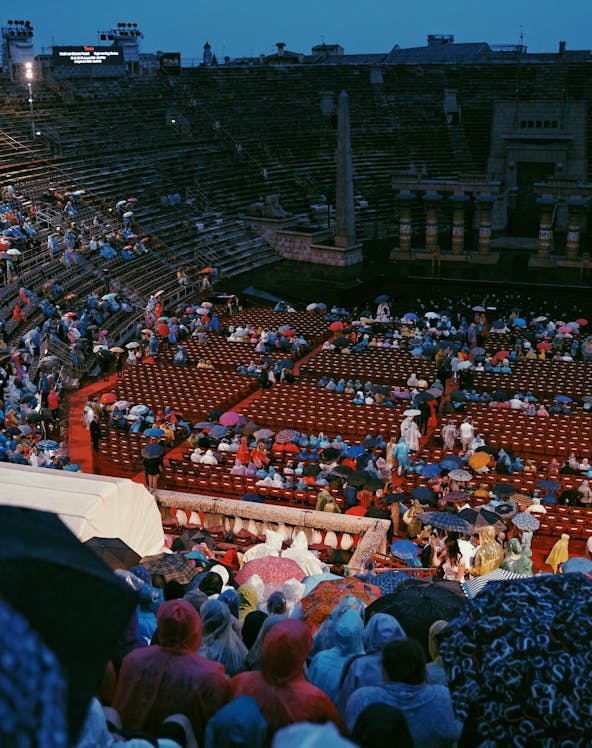 Crowd with umbrellas at Arena di Verona opera event in Verona, Italy.