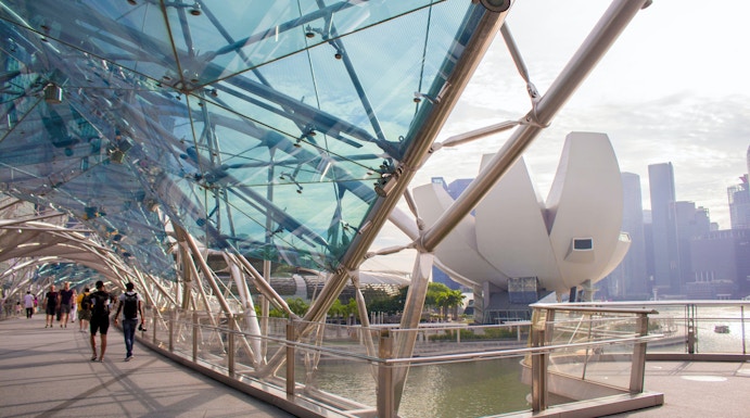 Helix Bridge with ArtScience Museum in Singapore background.