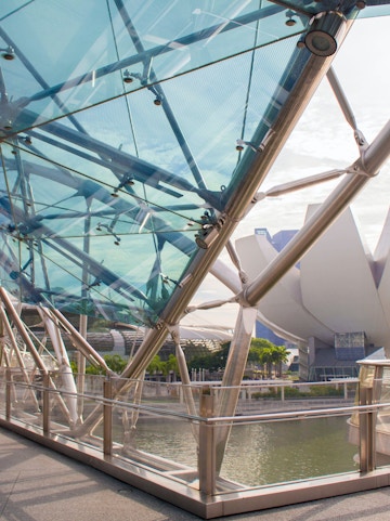 Helix Bridge with ArtScience Museum in Singapore background.