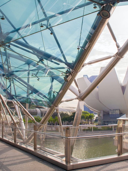 Helix Bridge with ArtScience Museum in Singapore background.