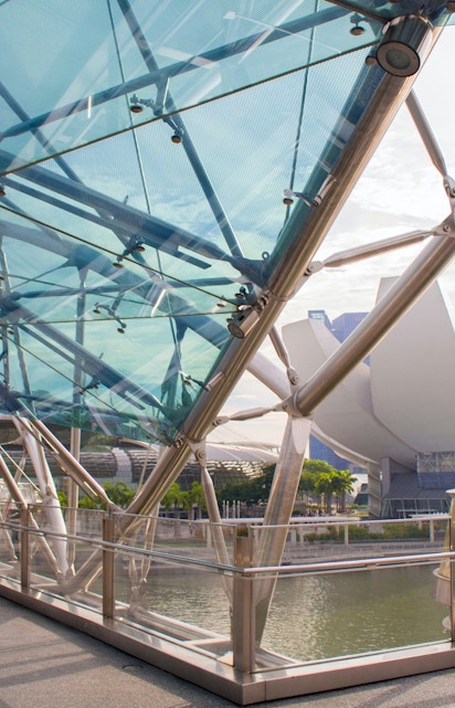 Helix Bridge with ArtScience Museum in Singapore background.