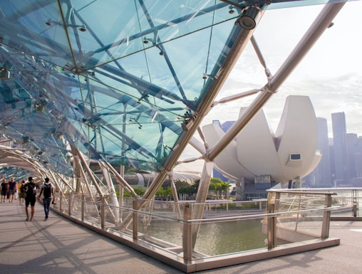 Helix Bridge with ArtScience Museum in Singapore background.
