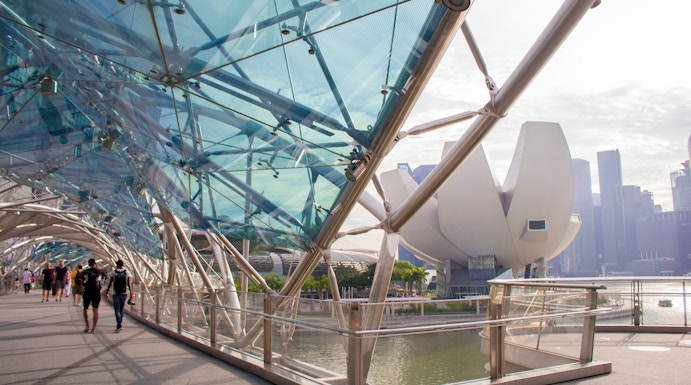 Helix Bridge with ArtScience Museum in Singapore background.