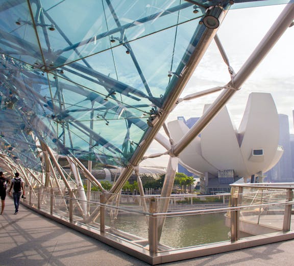 Helix Bridge with ArtScience Museum in Singapore background.