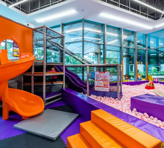 Indoor playground with slides and ball pit at Kiztopia Singapore.