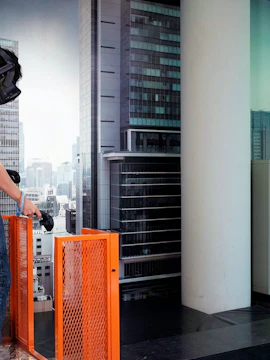 Person experiencing virtual reality at HeadRock VR Singapore with cityscape backdrop.