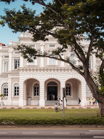 National Museum of Singapore facade with visitors walking nearby.