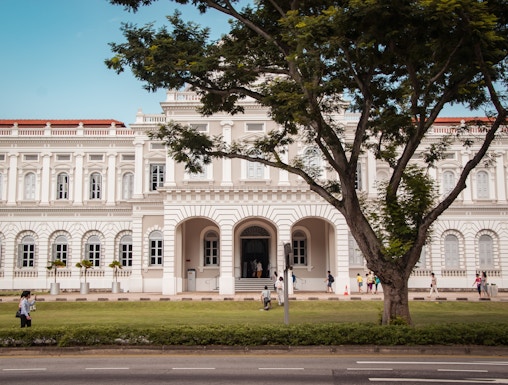 National Museum of Singapore facade with visitors walking nearby.