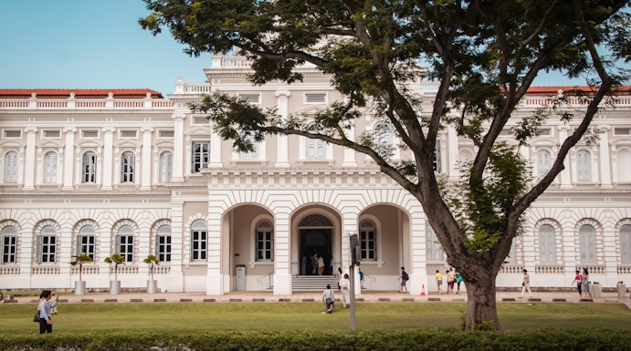 National Museum of Singapore facade with visitors walking nearby.