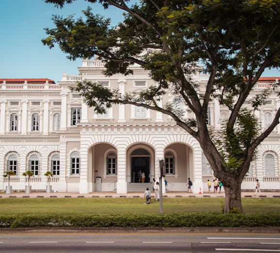 National Museum of Singapore facade with visitors walking nearby.