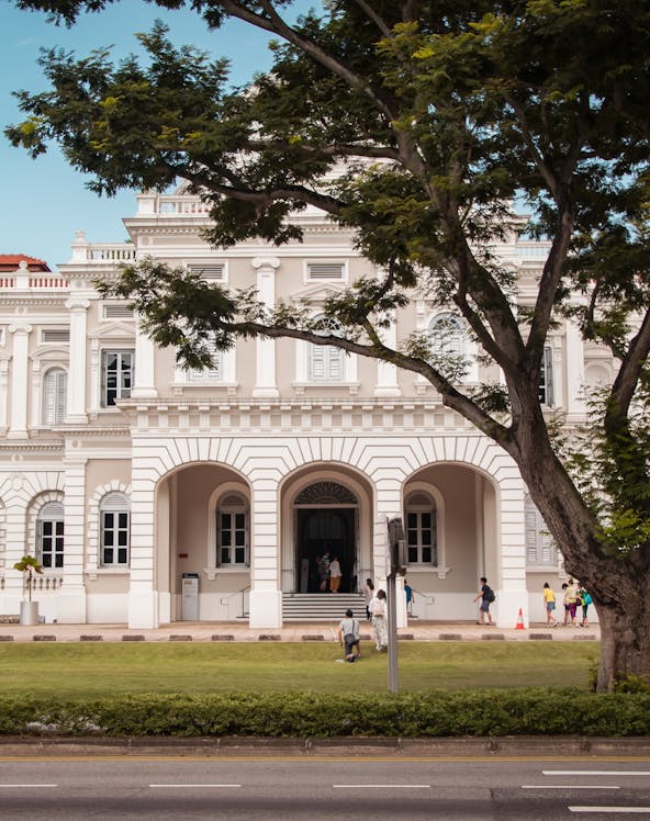 National Museum of Singapore facade with visitors walking nearby.