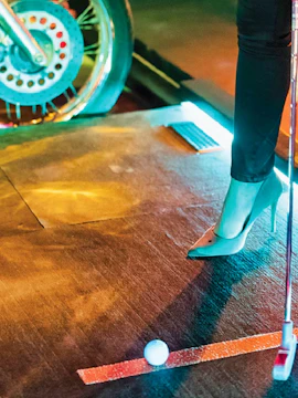 Mini golf setup at Holey Moley, Singapore with a motorcycle-themed obstacle.