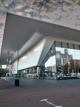 Modern architecture of the Stedelijk Museum in Amsterdam with reflective glass facade.
