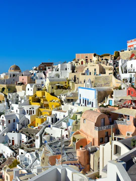 Santorini's iconic white and pastel buildings with a view of the Aegean Sea.