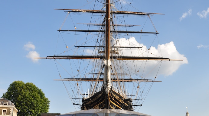 Cutty Sark ship in Greenwich, London, with visitors walking nearby.