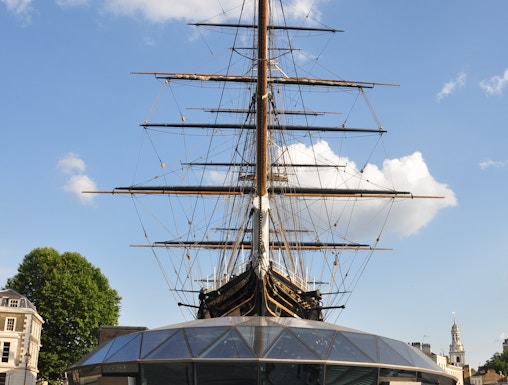 Cutty Sark ship in Greenwich, London, with visitors walking nearby.