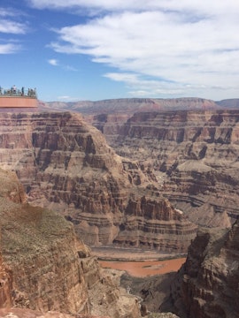 Grand Canyon Skywalk with visitors overlooking canyon views.
