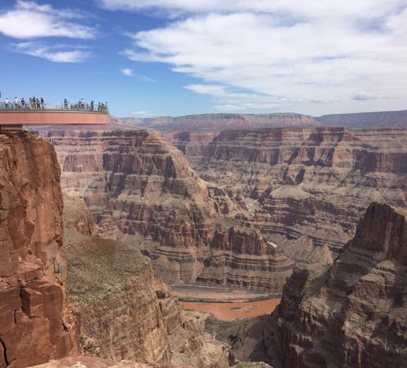 Grand Canyon Skywalk with visitors overlooking canyon views.