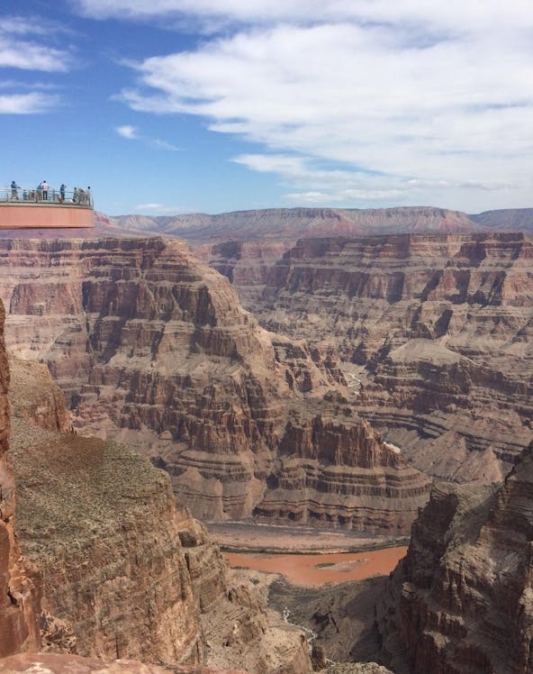 Grand Canyon Skywalk with visitors overlooking canyon views.