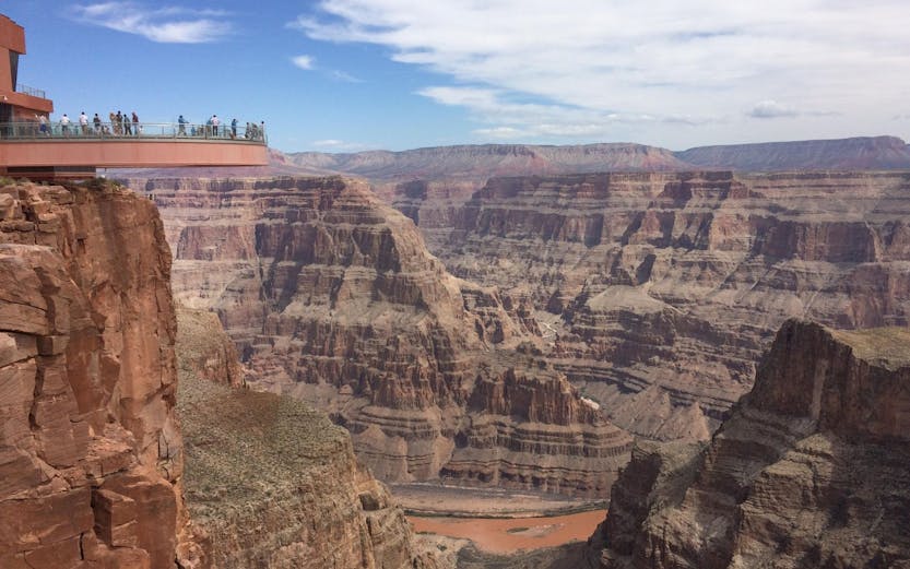 Grand Canyon Skywalk with visitors overlooking canyon views.