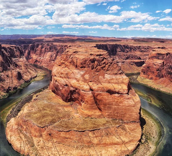 Horseshoe Bend in Arizona with the Colorado River curving around red rock formations.