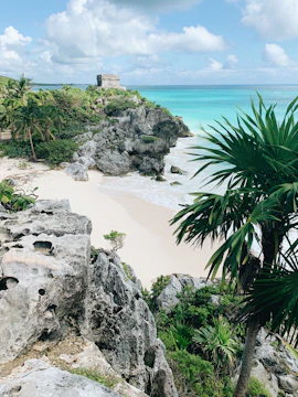 Ancient ruins on a rocky cliff overlooking a beach in Cozumel.
