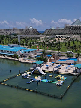 Aquabounce water park in Cancun marina with inflatable slides and obstacles.